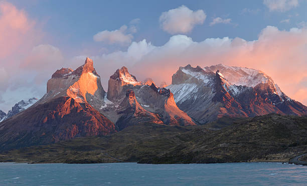 Jagged granite peaks reflected in a turquoise lake in Patagonia